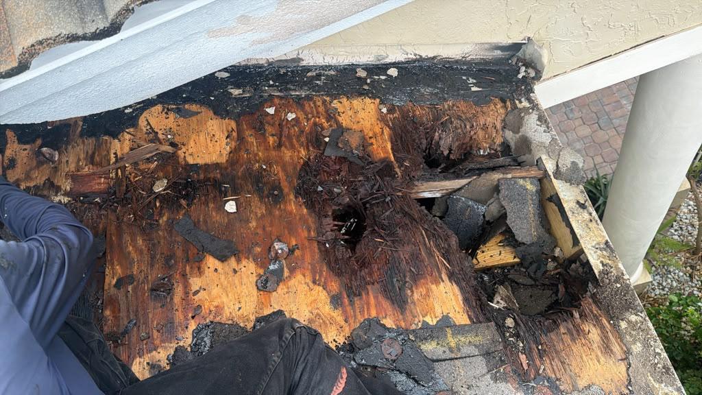 Rotted plywood roof decking found under intact tiles during a Broward County roof repair