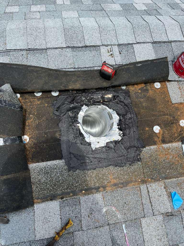 Modified bitumen mastic bedded around a new kitchen exhaust duct penetration on a shingle roof deck