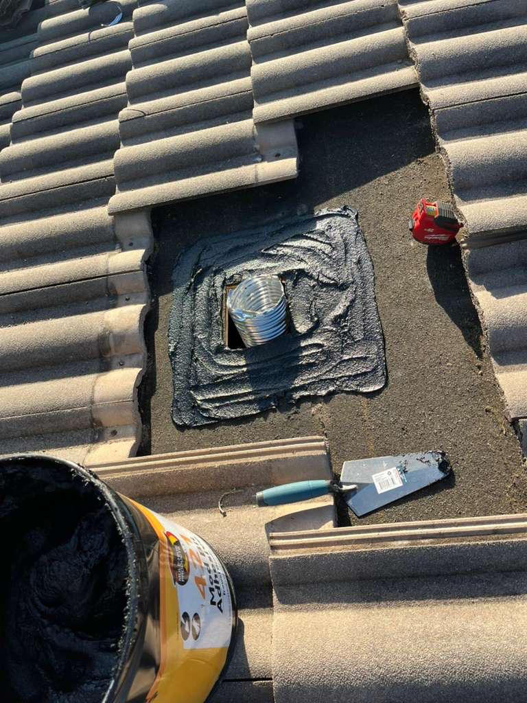 Modified bitumen mastic bedded around a roof vent penetration during a goose-neck replacement on a Broward County tile roof
