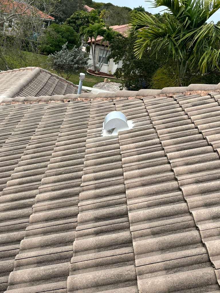 Wide view of a completed tile roof after a goose-neck vent replacement in Broward County, Florida