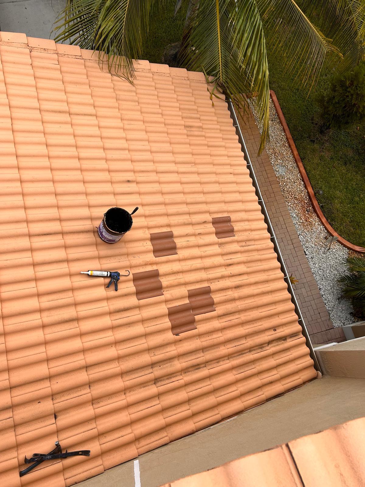 Matching replacement concrete tiles set into a repaired section of tile roof in Broward County, Florida