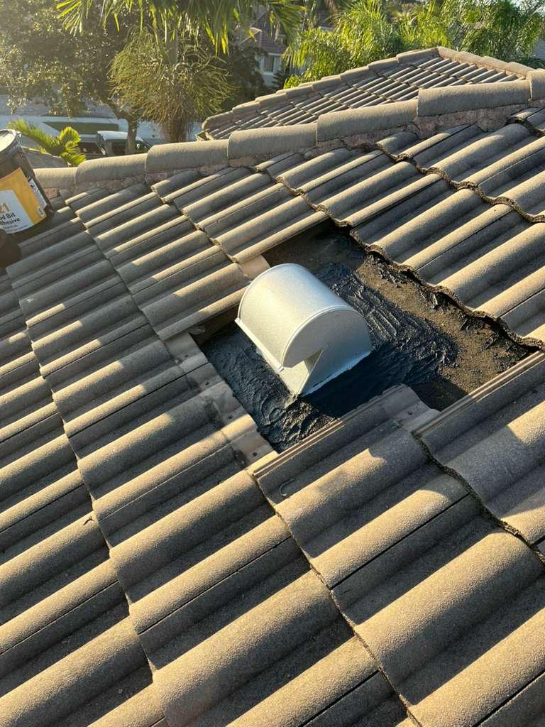 Goose-neck vent flashing fully sealed in modified bitumen mastic on a Broward County tile roof repair