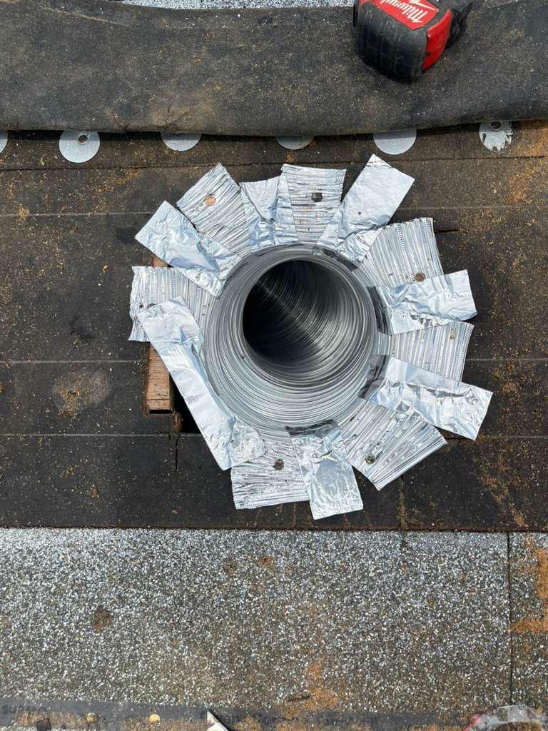 Flexible kitchen exhaust duct fastened and foil-taped to the roof deck on a shingle roof in Broward County, Florida
