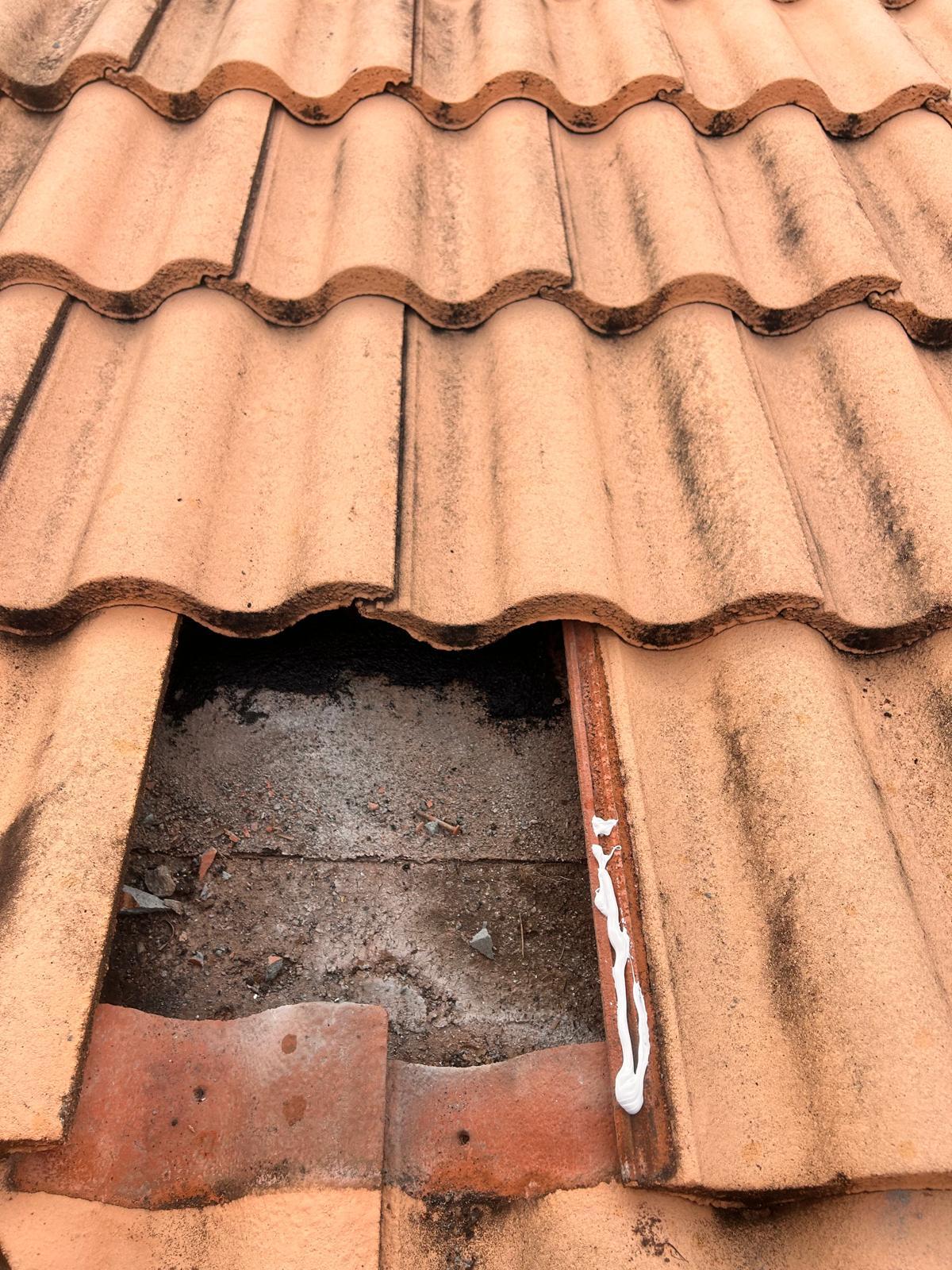 Sealant bead applied along the tile pan and underlayment seam during a tile roof leak repair in Broward County, Florida