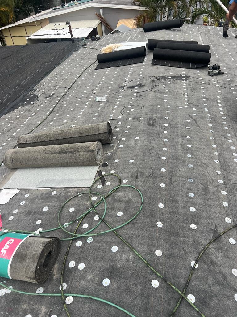 Base sheet fastened, cap sheet staged for install