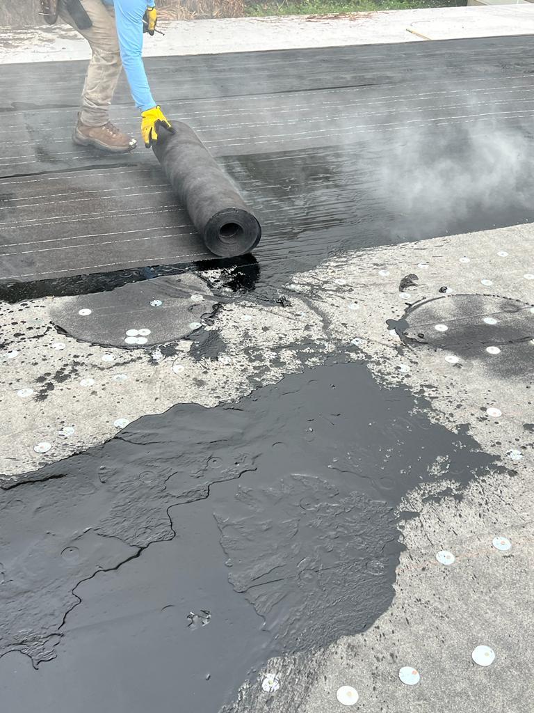 Cap sheet rolled into hot asphalt, lap by lap