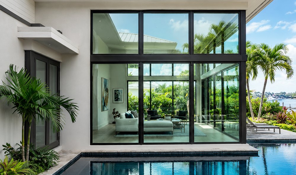 Modern South Florida home with floor-to-ceiling hurricane impact glass by Safetech Roofing and Windows
