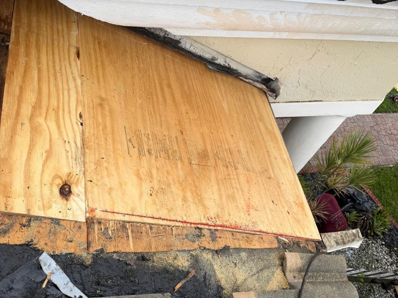 New CDX plywood sheathing fastened at a tile roof eave with a red chalk line marking the cut