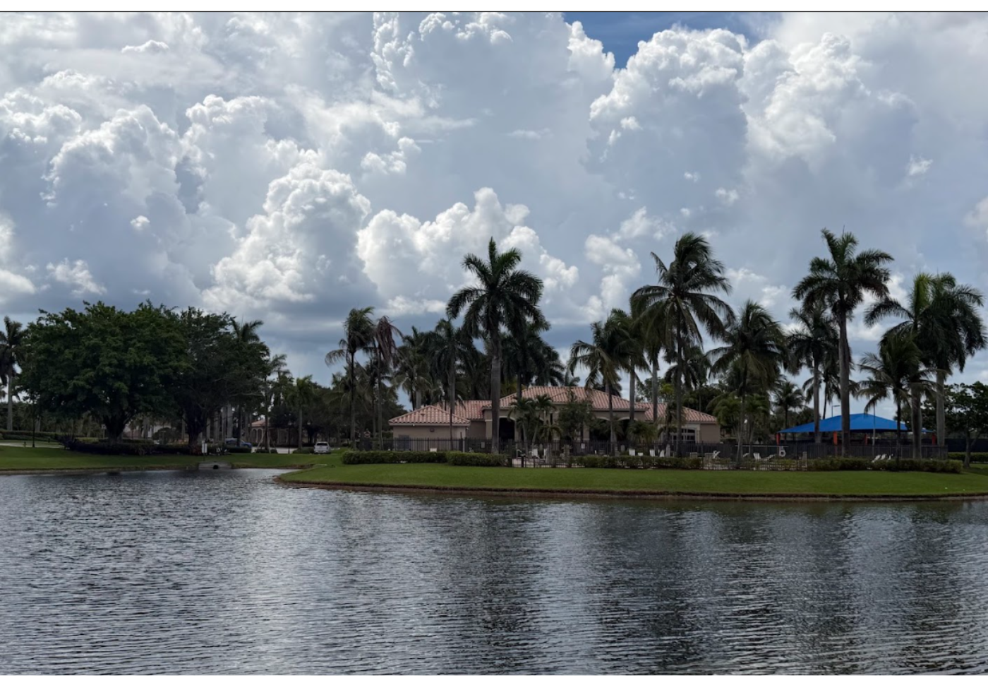 Afternoon storm clouds building over the lake and clubhouse in Encantada, Pembroke Pines FL
