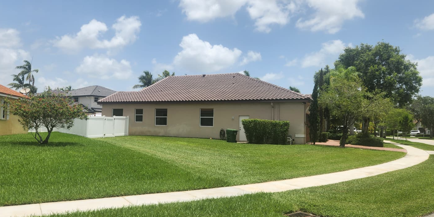 Rear elevation of a tile-roof home backing onto open ground in Pembroke Pines