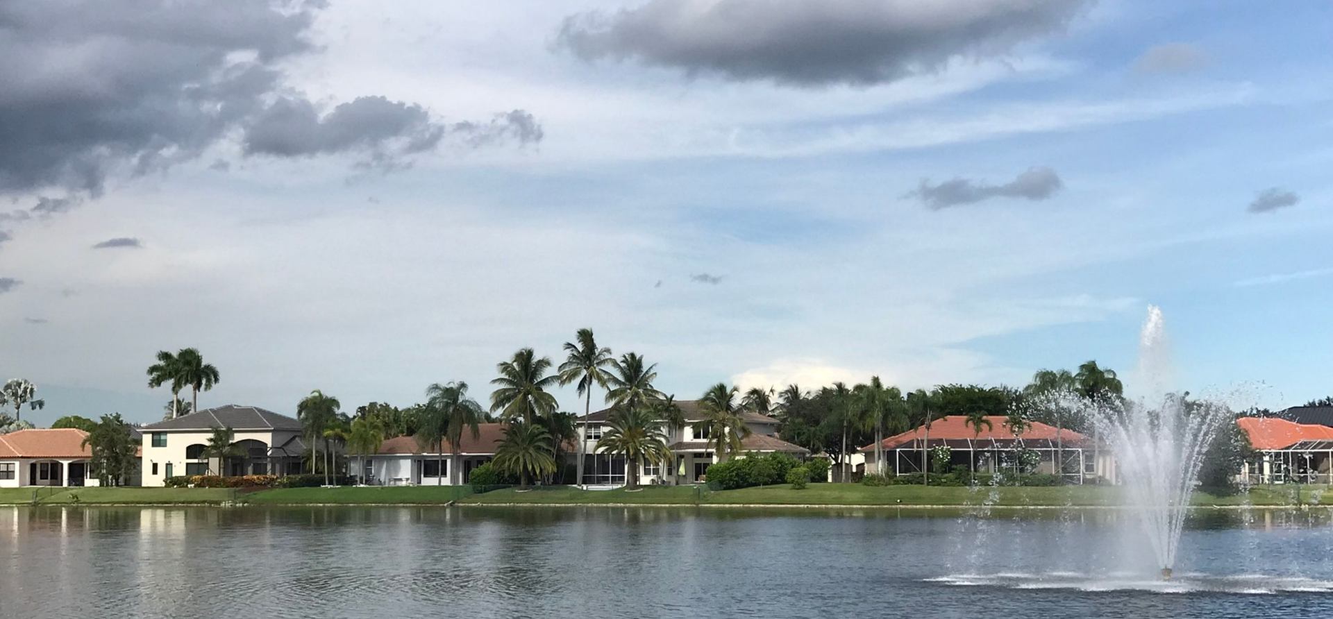 Lakefront tile-roof homes and fountain in the gated Pembroke Shores community, Pembroke Pines FL