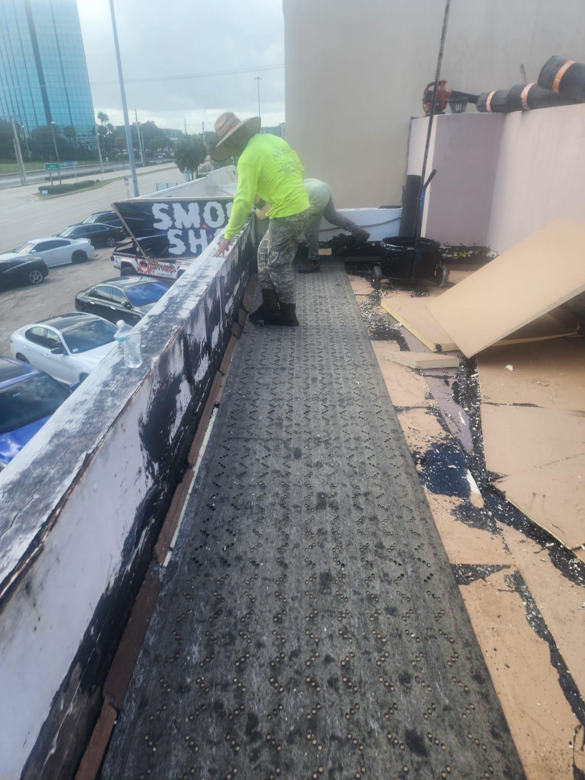 Base sheet mechanically fastened over insulation on a commercial flat roof in Broward County, Florida