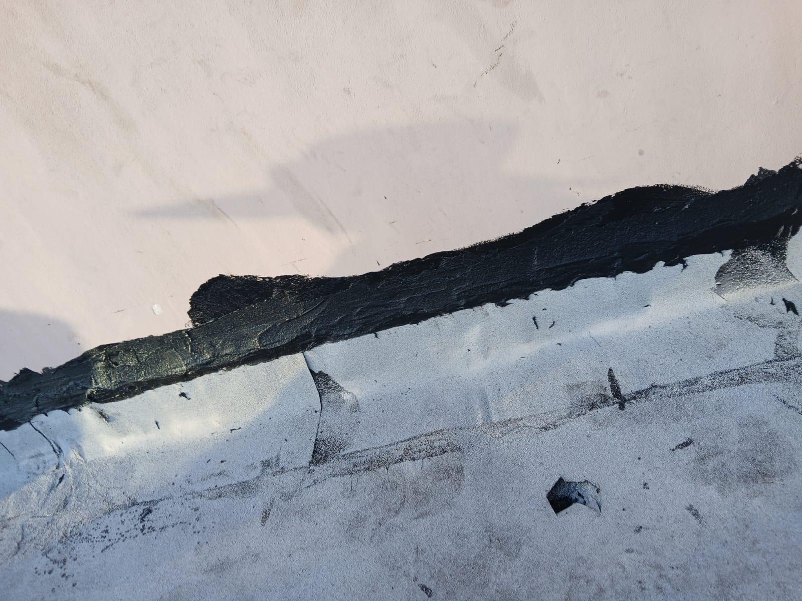 Cap sheet turned up and terminated at a parapet wall on a completed commercial flat roof in Broward County, Florida