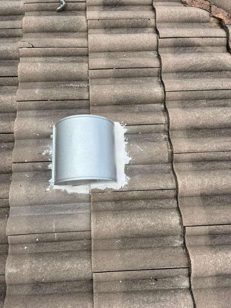 Close view of a completed goose-neck vent replacement on a tile roof in Broward County, Florida