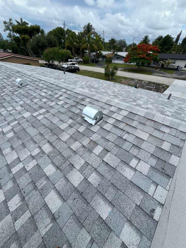 Completed shingle roof with a new kitchen exhaust goose-neck vent in Broward County, Florida