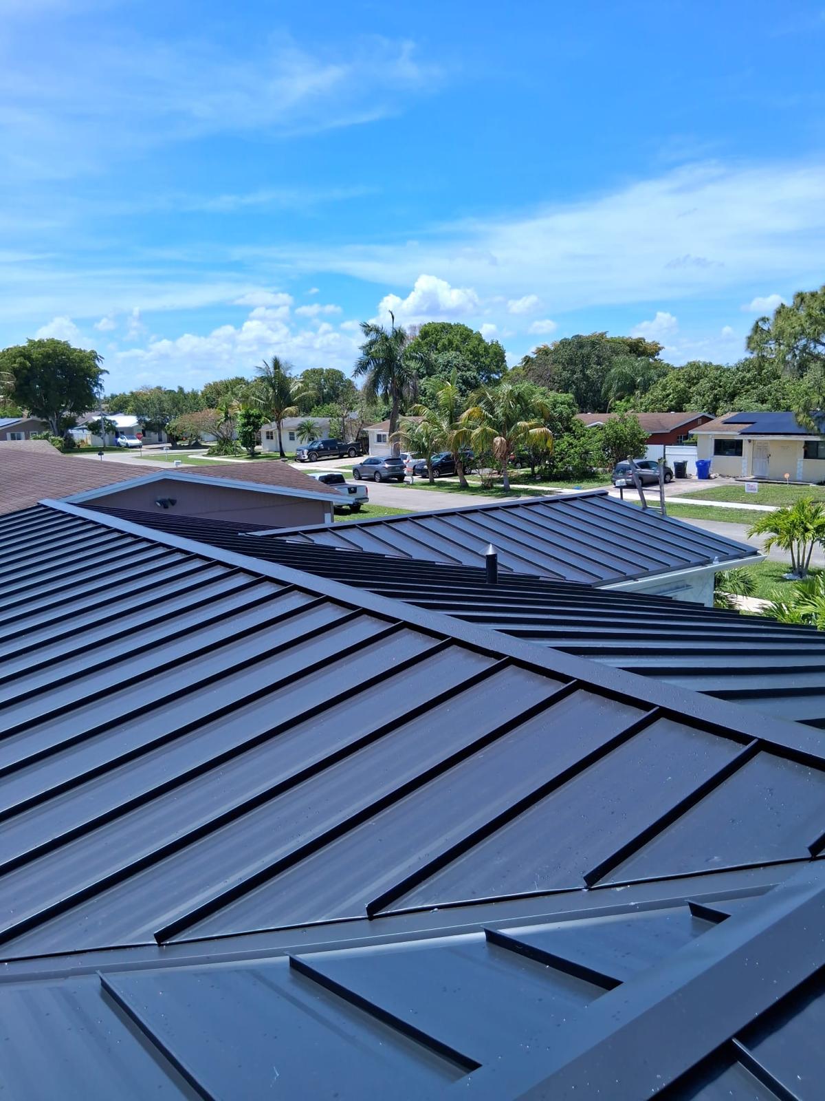 Dark standing-seam metal hip roof installed in Broward County, Florida