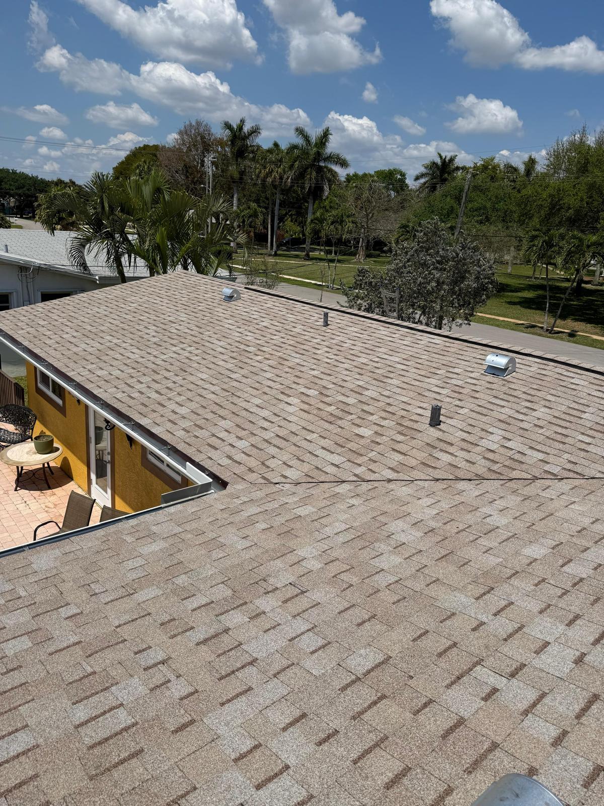 Completed tan architectural shingle roof photographed wide in Broward County, Florida