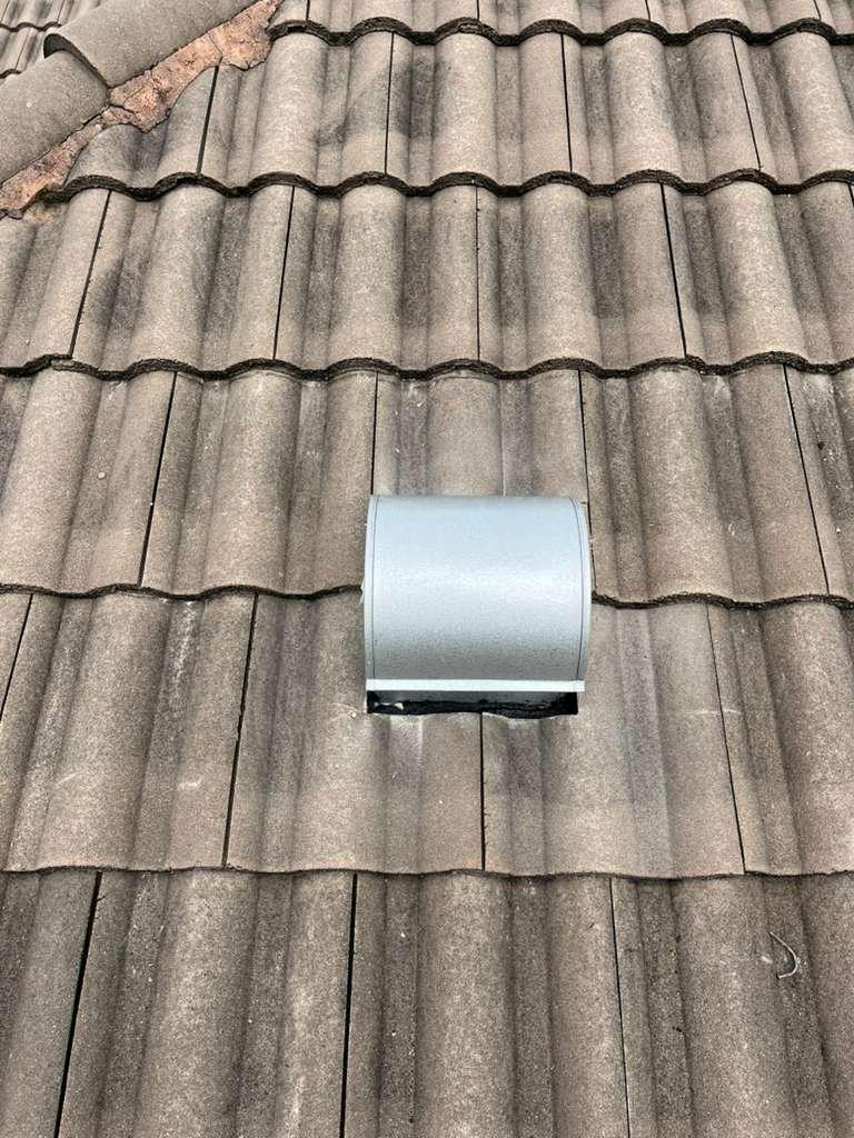 Rusted goose-neck vent removed from a tile roof in Broward County, Florida