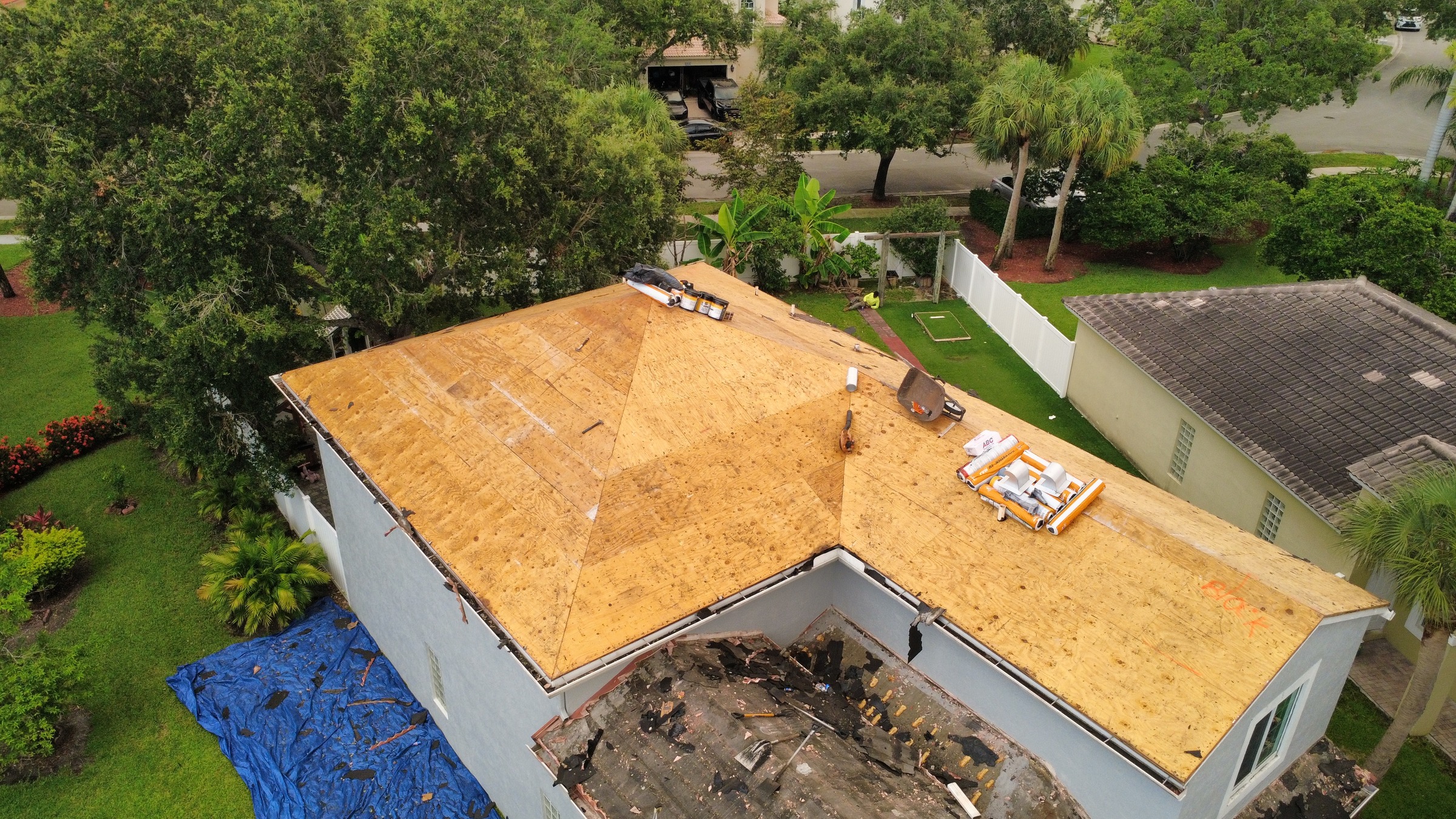 Roof decking exposed after tile tear-off, photographed by drone in Broward County, Florida