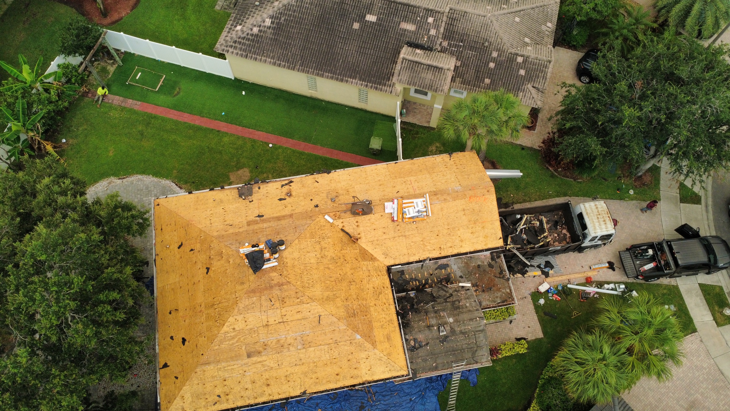 New plywood roof decking installed across a Broward County, Florida roof, photographed by drone