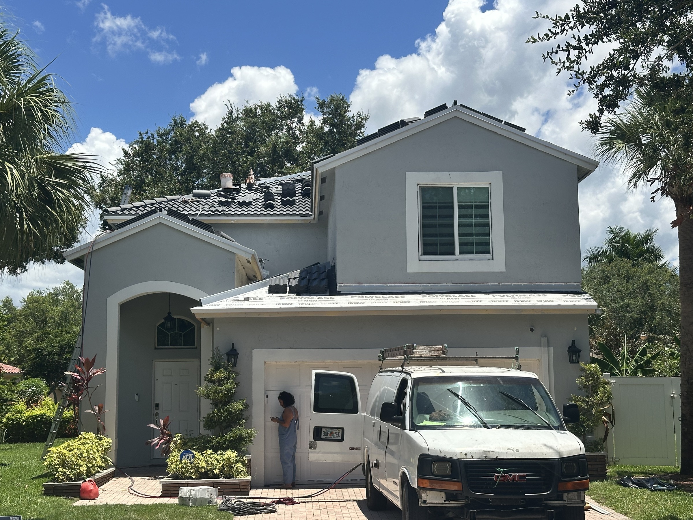 Underlayment installed with replacement tiles staged on a Broward County, Florida roof