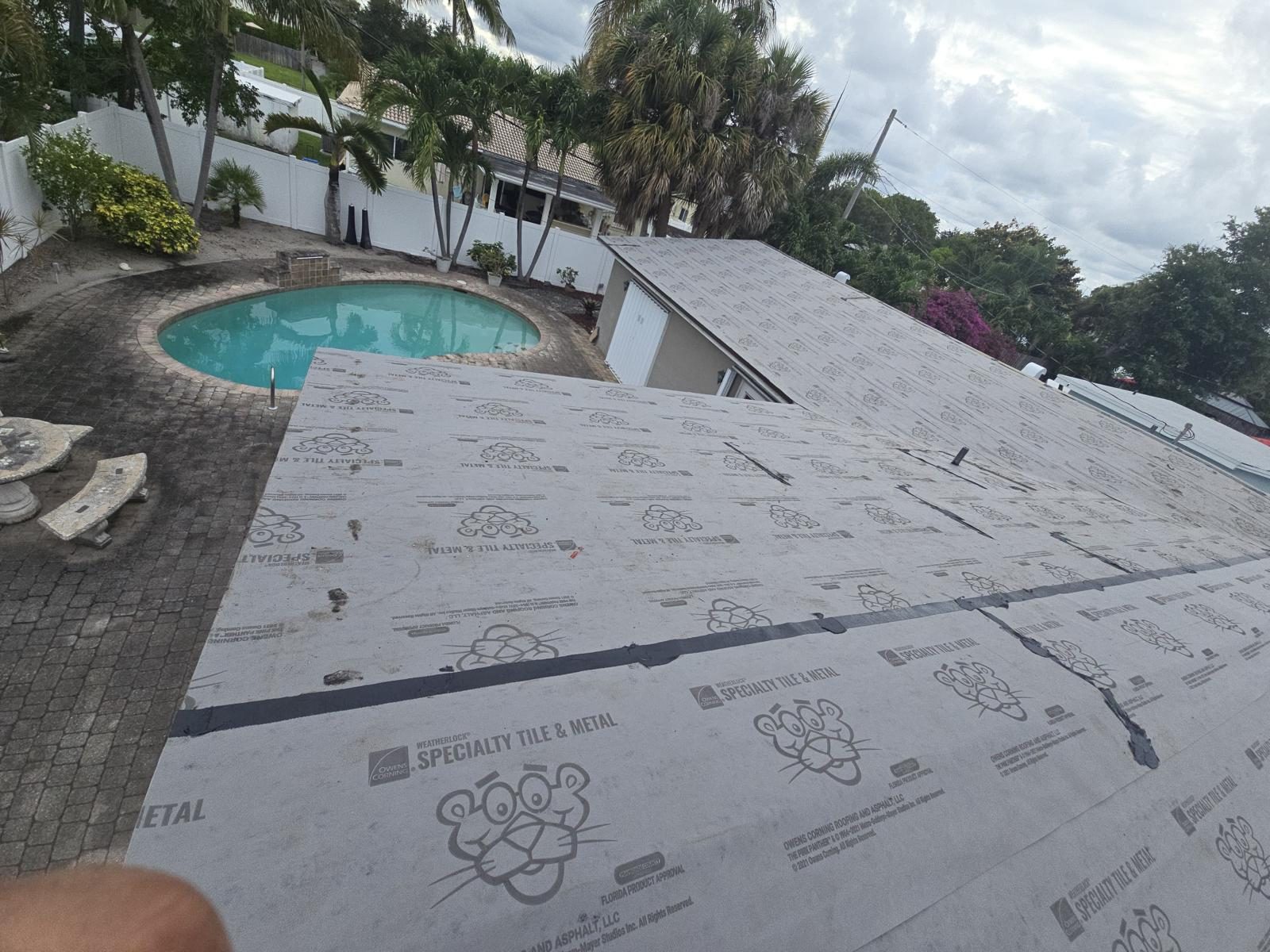 Old shingles and underlayment torn off exposing the plywood decking and framing on a Broward County shingle roof