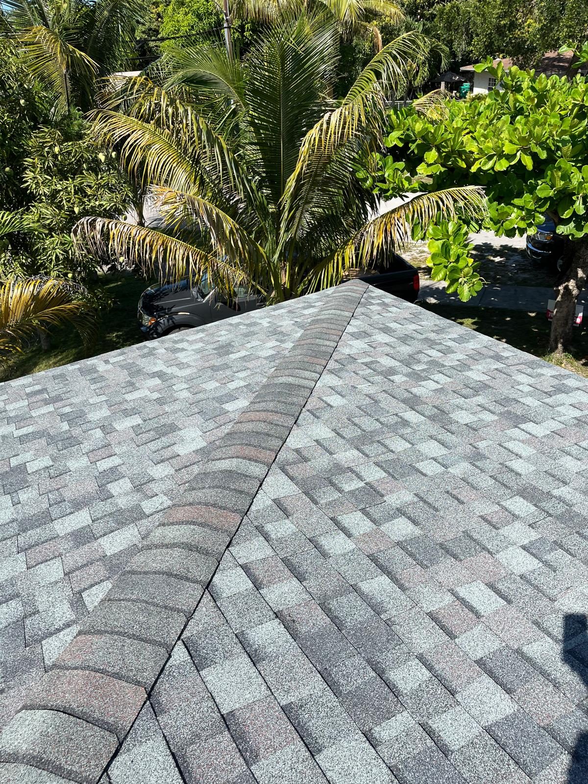 Completed architectural shingle roof in Broward County, Florida, showing a clean hip and ridge line