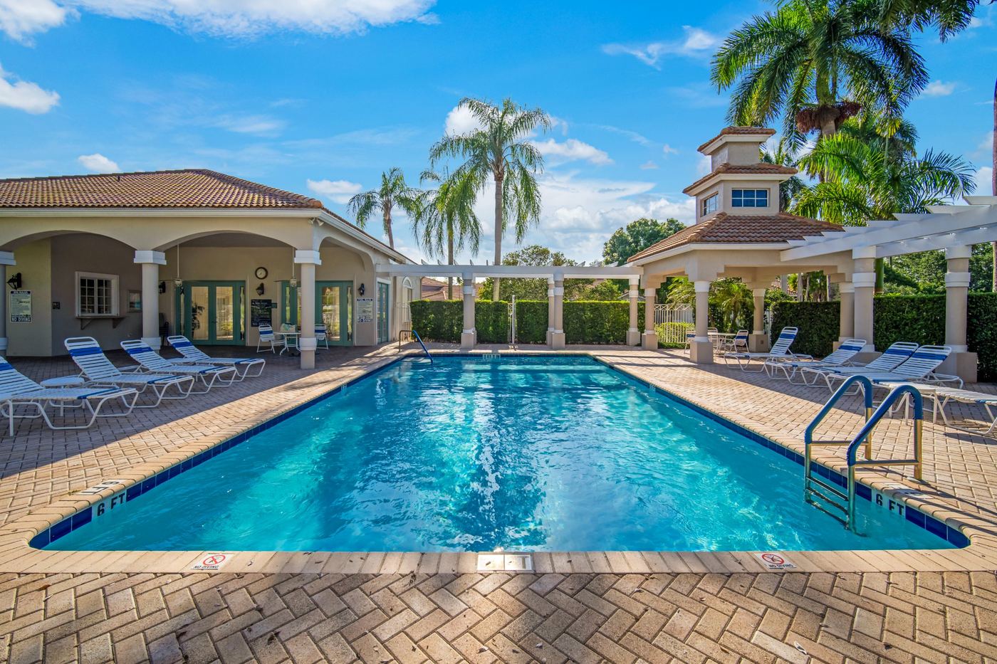 Tile-roofed clubhouse and pool deck in a Fort Lauderdale, Florida HOA community