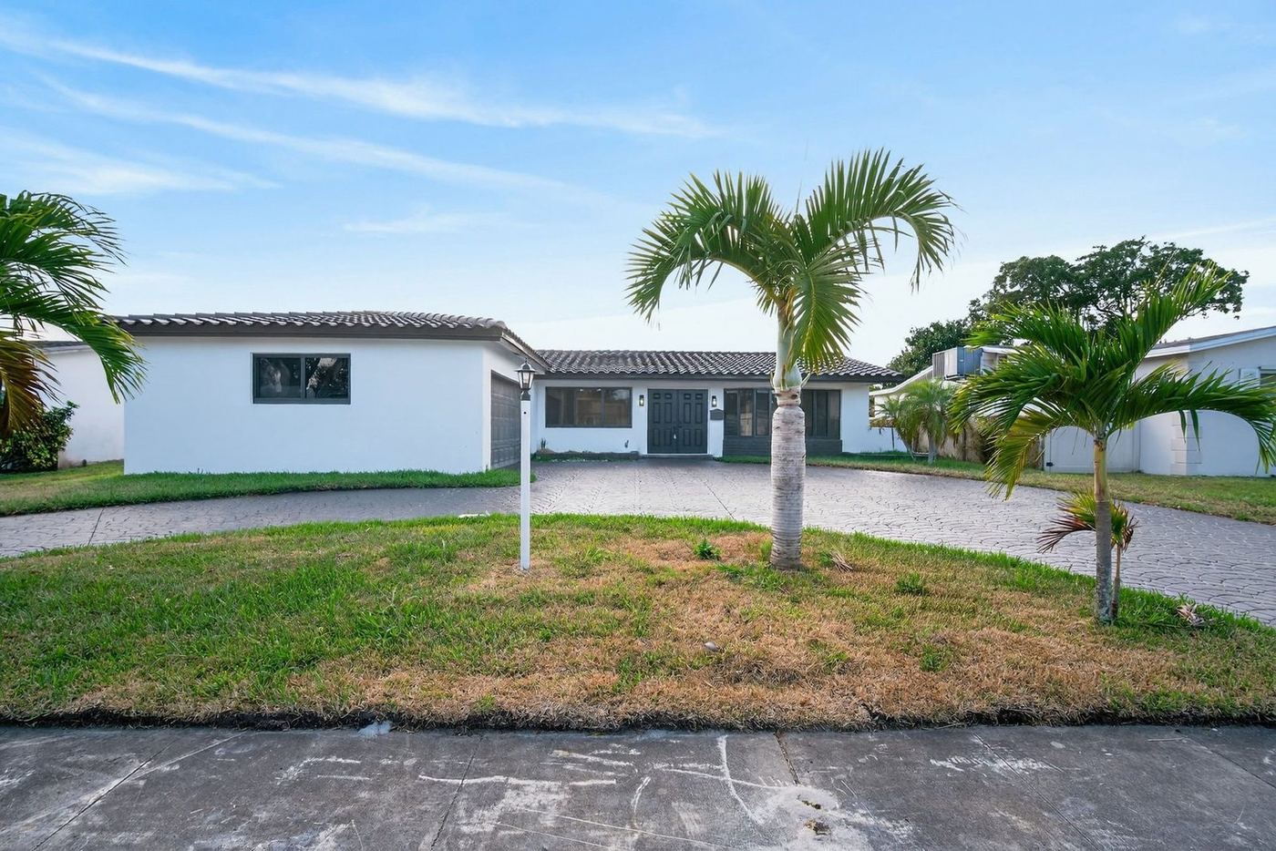 Low-pitched concrete tile roof over a white stucco home in South Florida