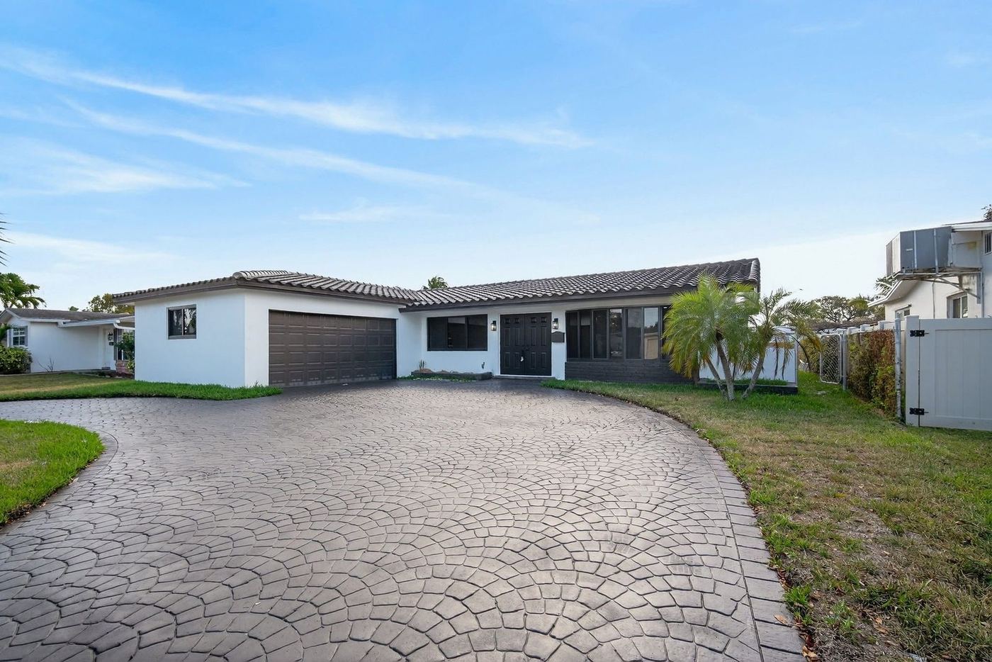 Concrete tile roof continuing over an attached garage wing in South Florida