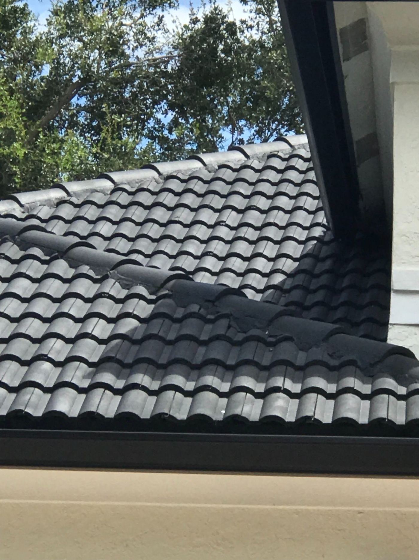 Close view of a barrel tile roof ridge and hip detail on a South Florida home