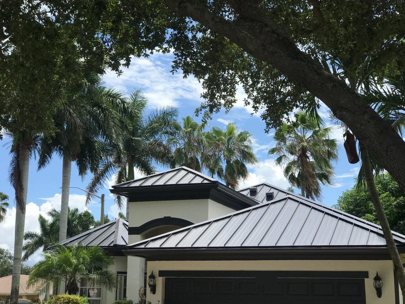 Dark standing-seam metal roof on a single-story home in Miramar, Florida