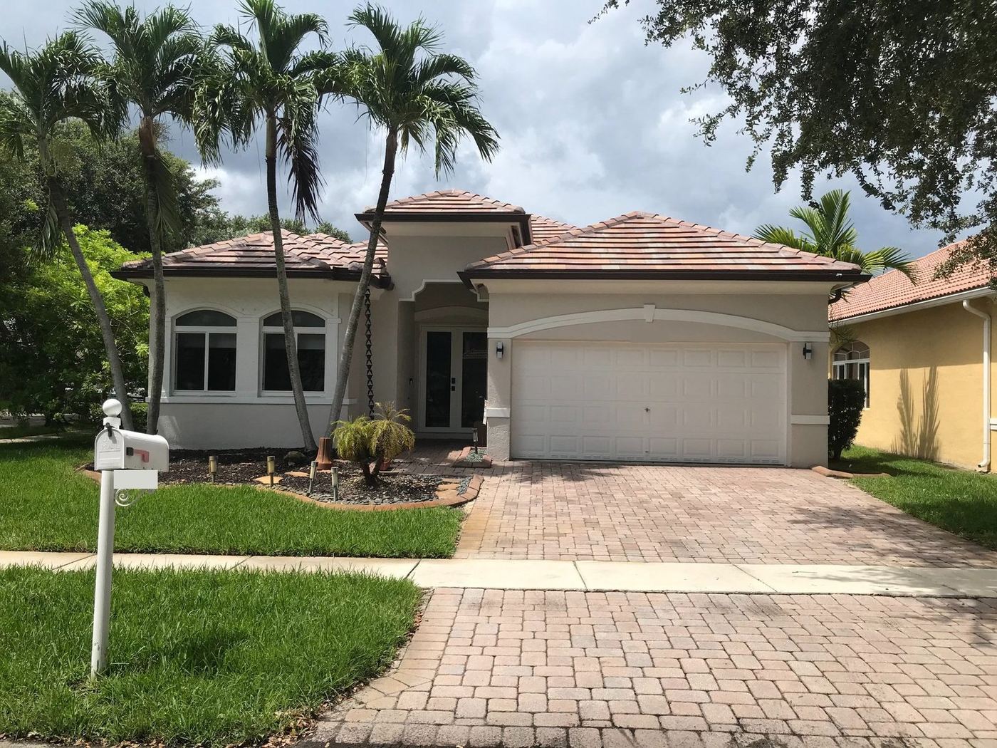 Single-family home with a flat concrete tile roof in Miramar, Florida