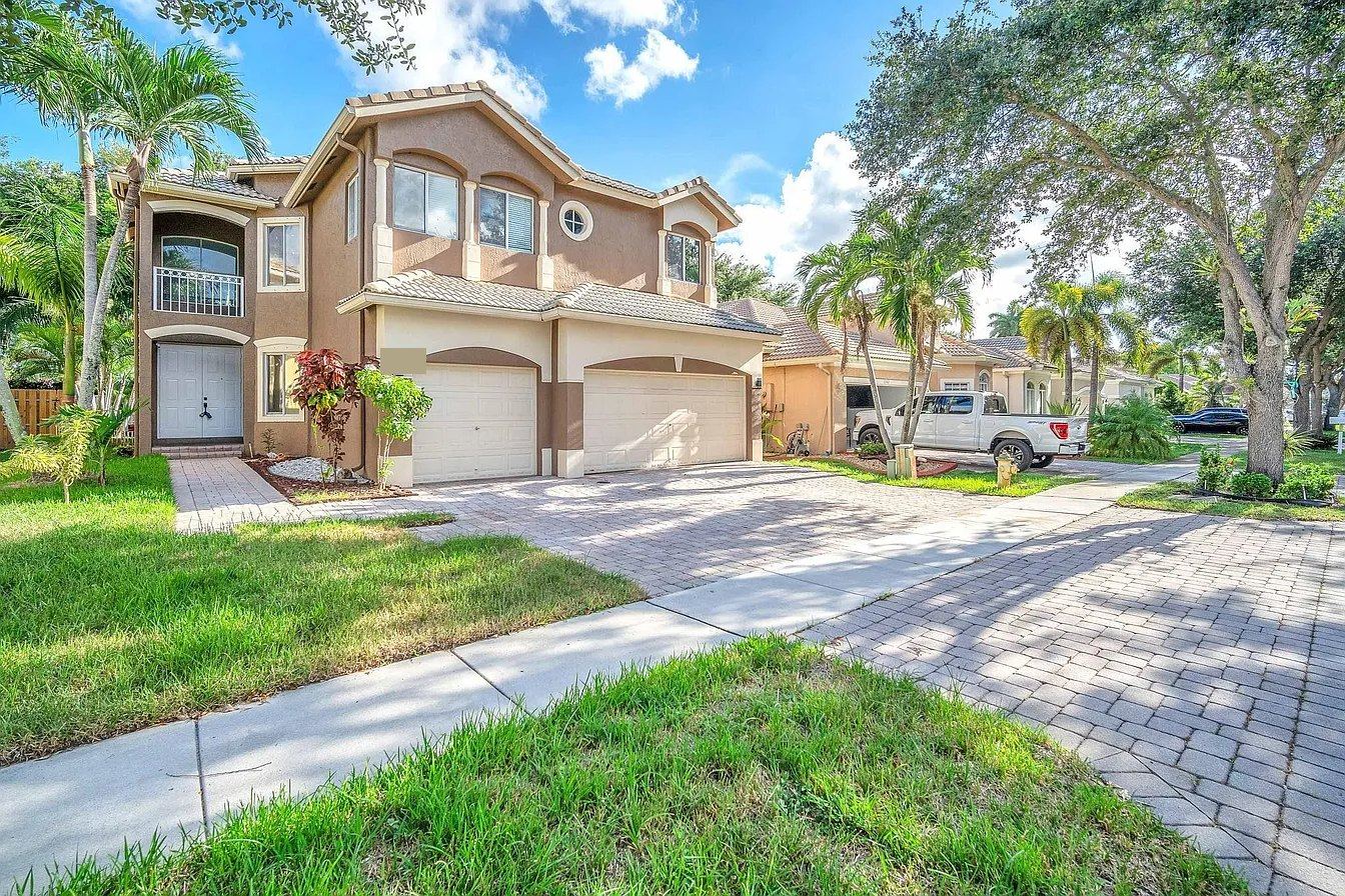 Two-story home with a light concrete tile roof and hip ridges in Miramar, Florida