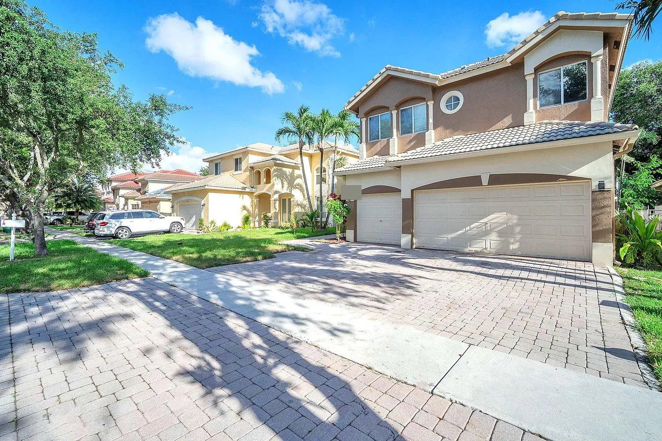 Street of two-story tile-roofed homes in a Miramar, Florida community