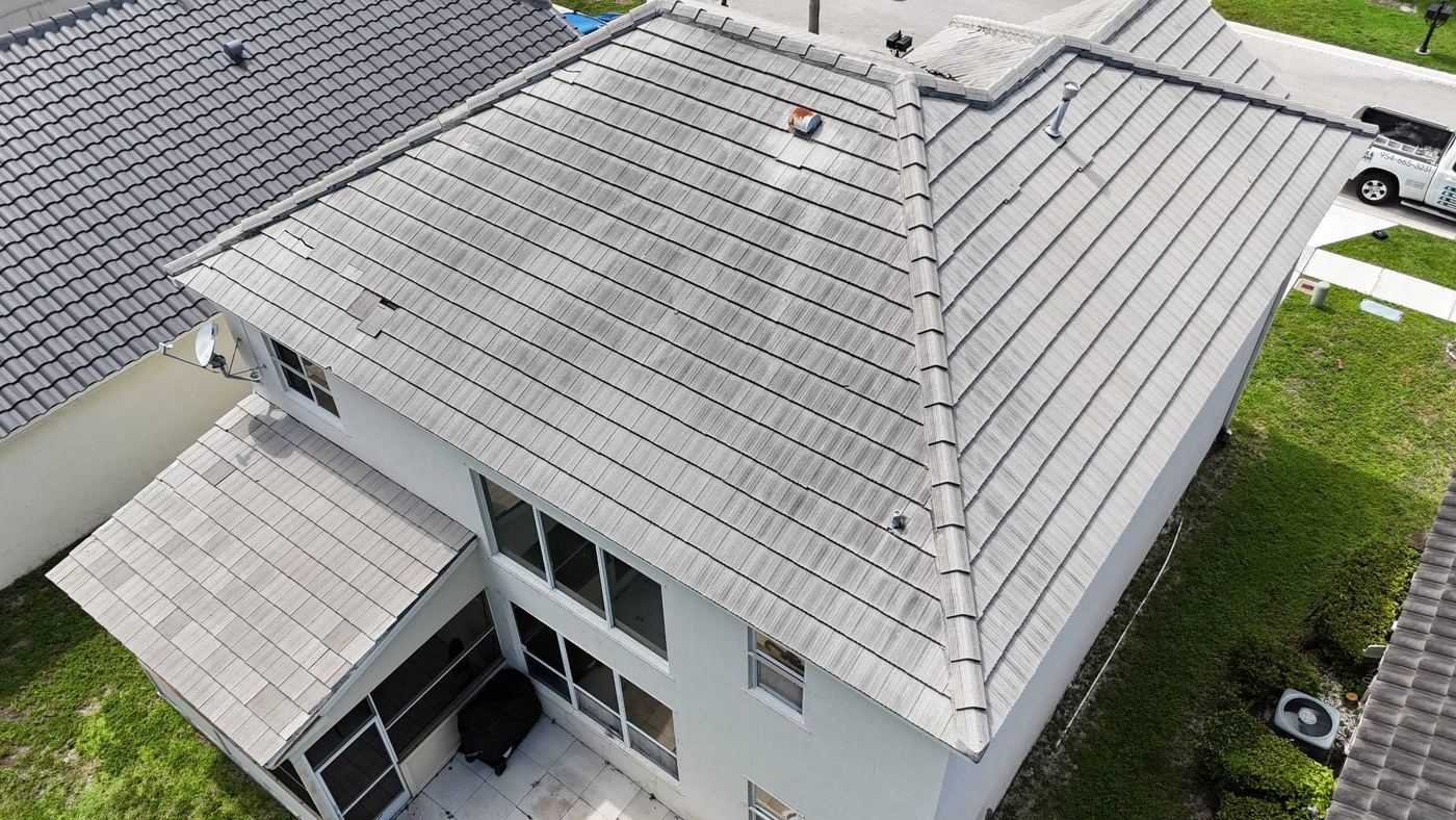 Rear slopes of a flat concrete tile roof in Tamarac, Florida showing slipped tiles and weathering